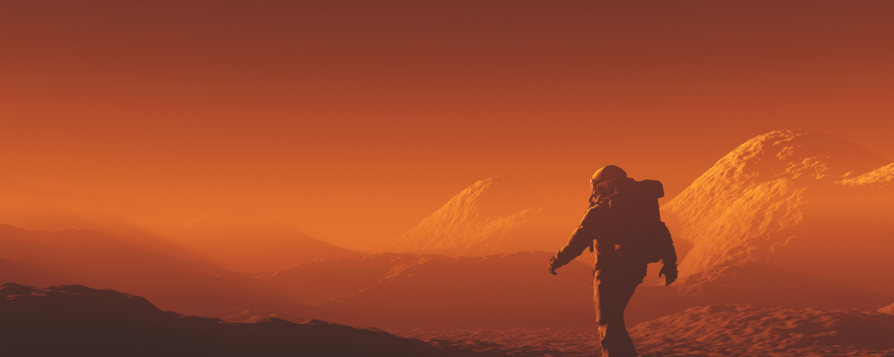 An astronaut on a vast red planet like mars