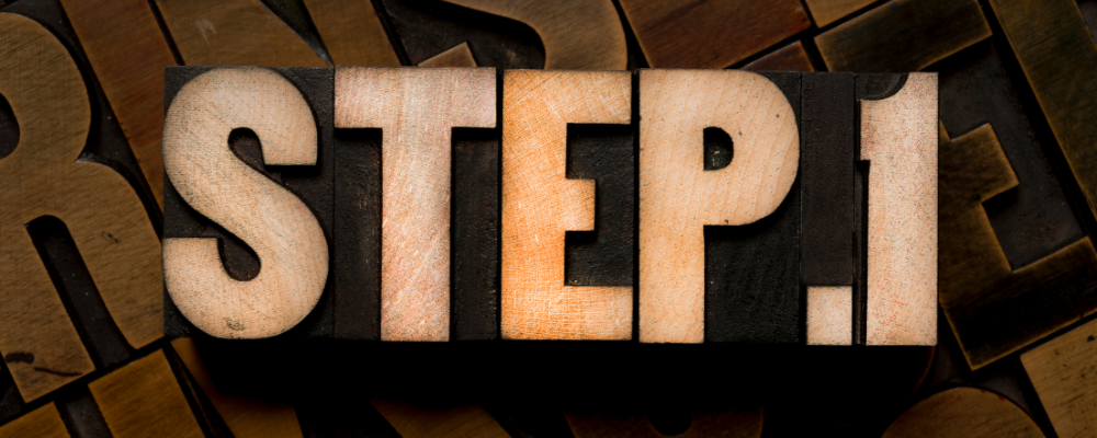 the words step 1 spelled out with wooden letters