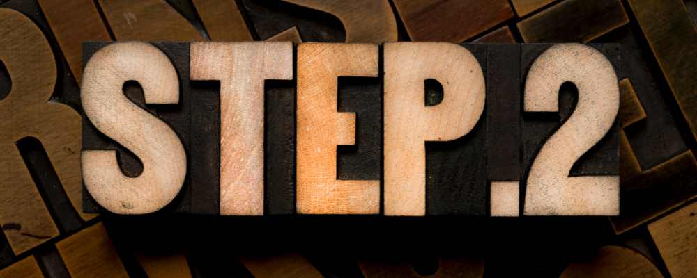 the words step 2 spelled out with wooden letters