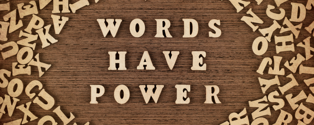 the words words have power spelled out with wooden letters